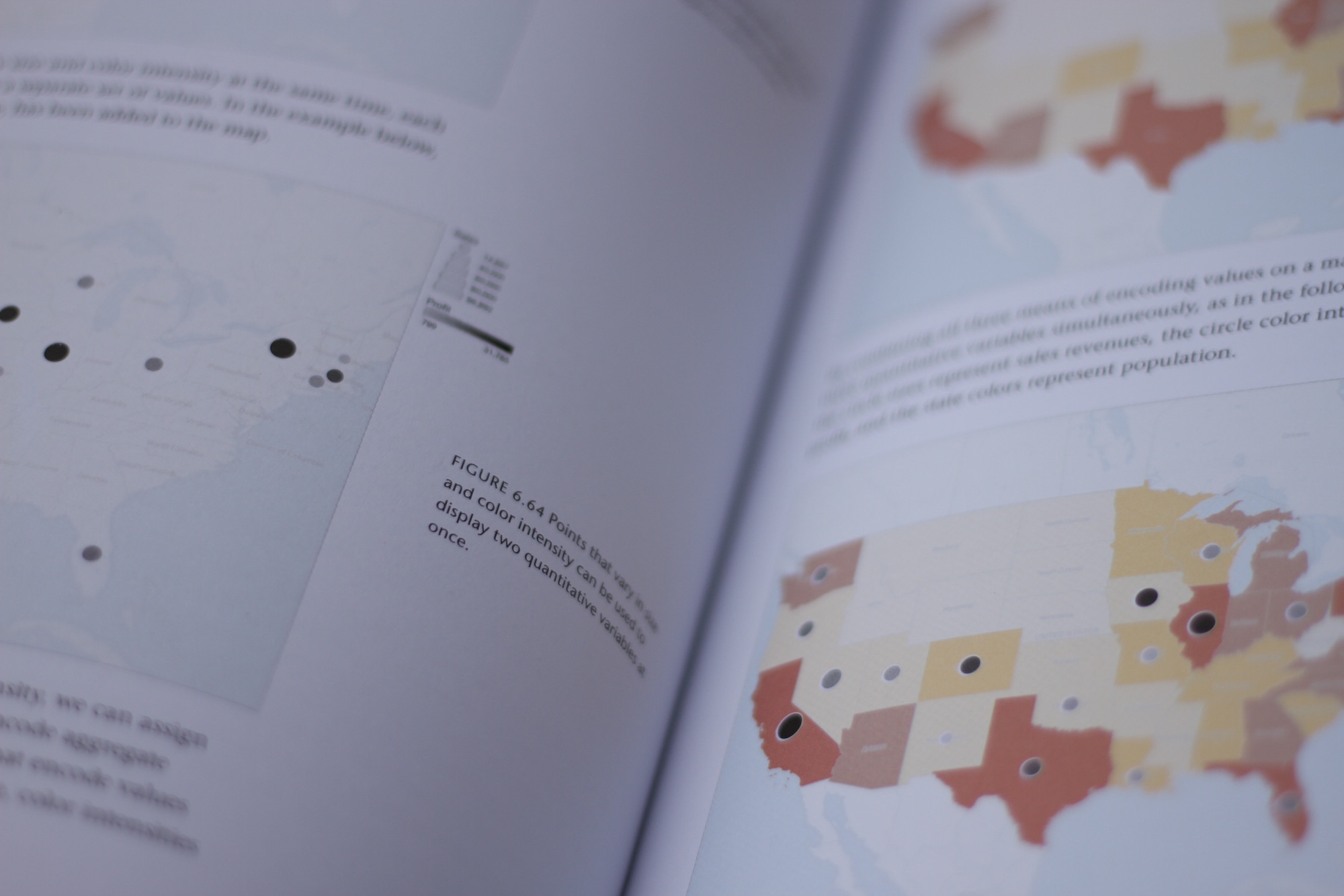 Close up view of a book crease with maps of the US on both pages