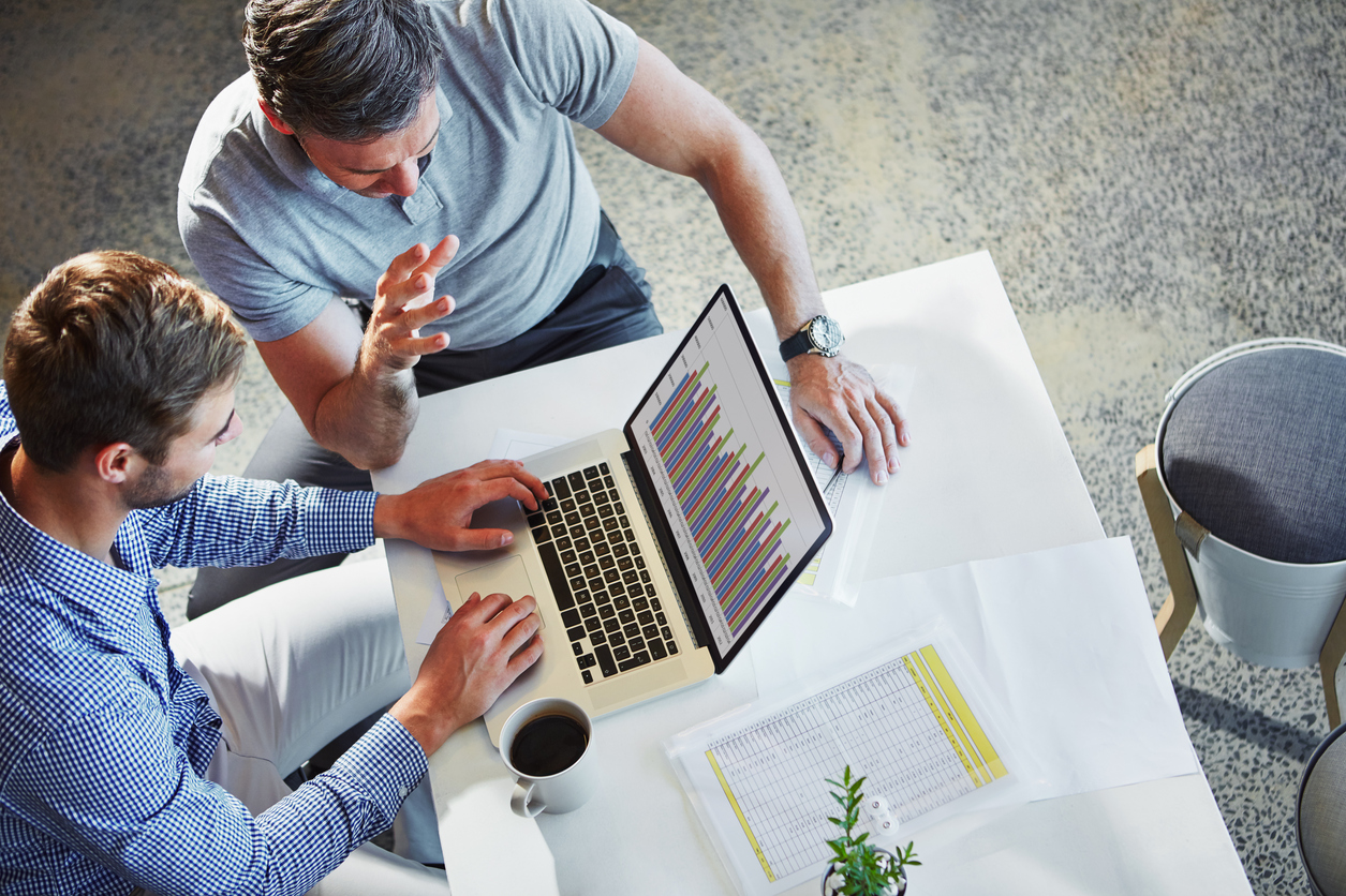 Turn Your Survey Responses into Insightful Data Blog: Shot of two colleagues using a laptop in a meeting at the office