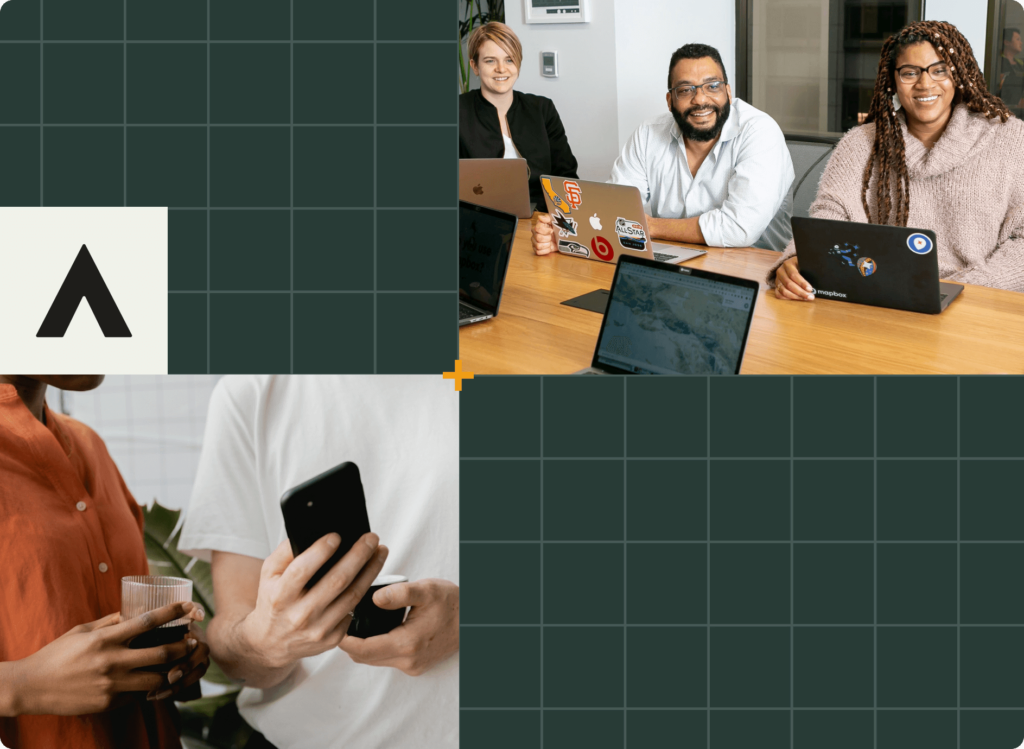Four people gathered around a table with laptops, smiling. Two hold a smartphone and a drink. Background features a grid pattern with an A logo in the corner.
