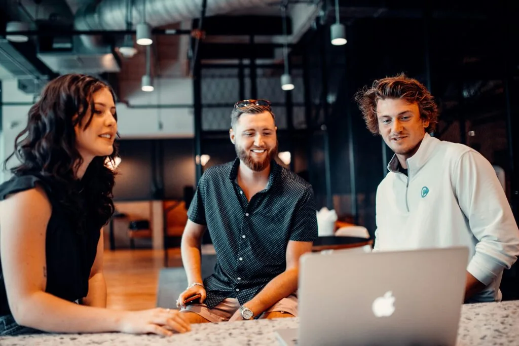 Three coworkers having a group meeting.