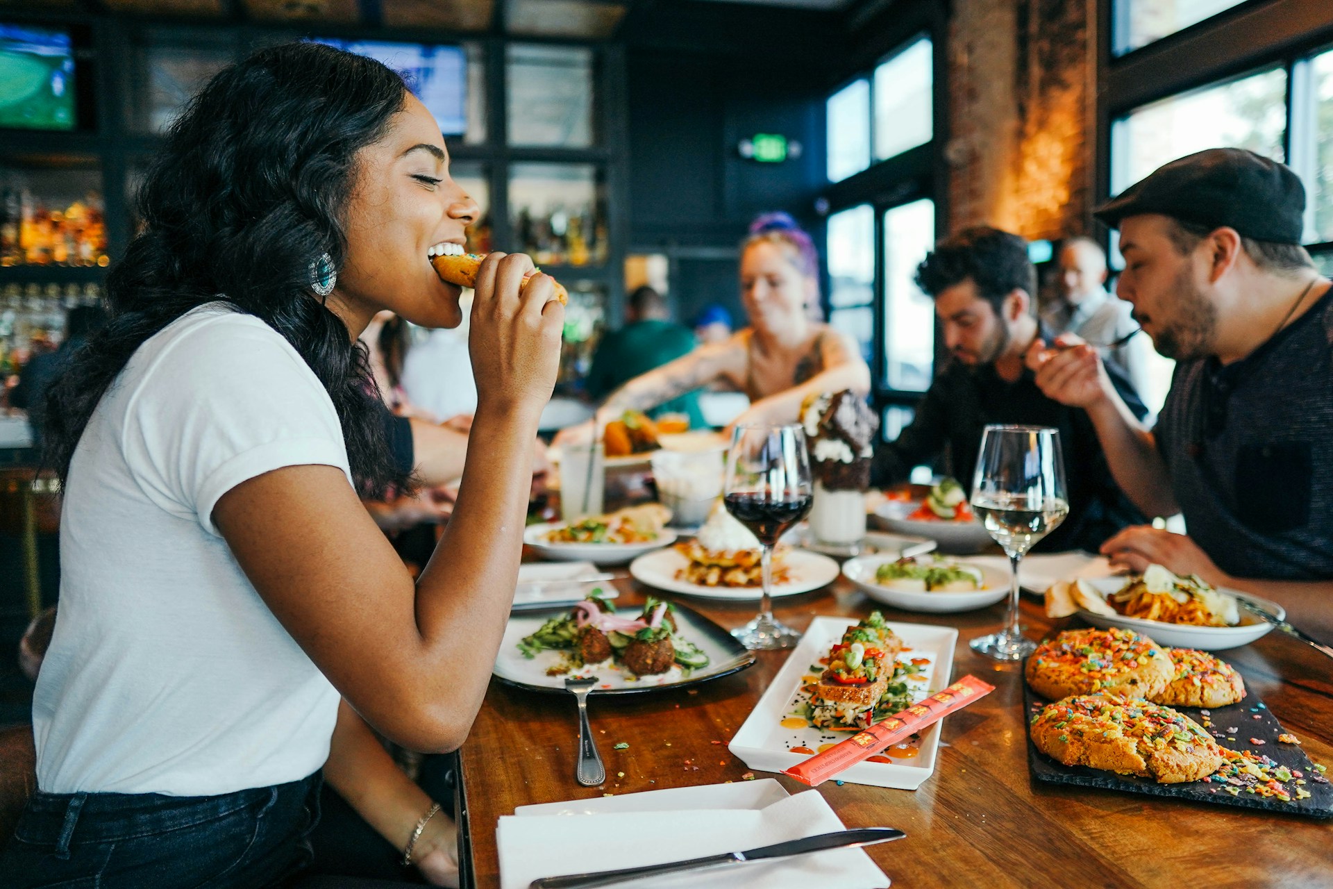 Group of friends eating at a restaurant and sharing food