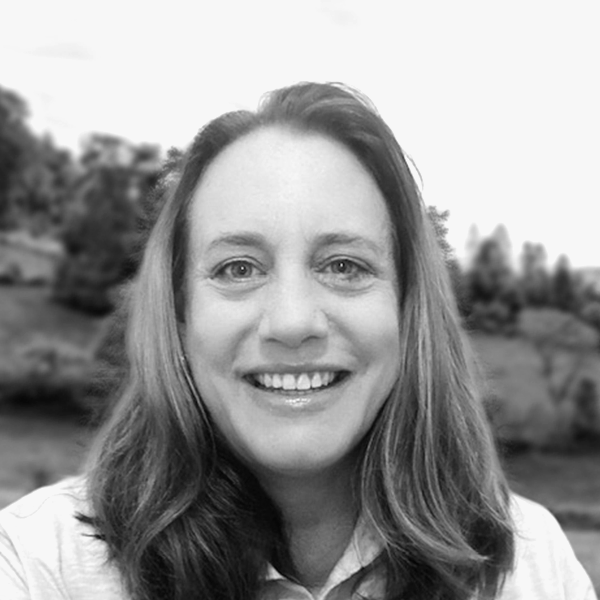 Headshot of a woman smiling with shoulder length hair