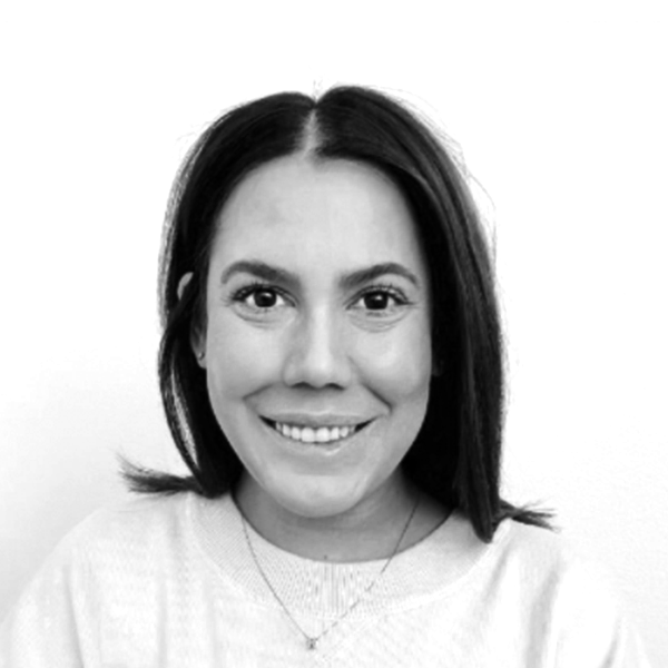 Headshot of a woman smiling with shoulder length hair